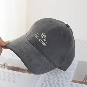 Detail of dark gray corduroy baseball cap featuring white embroidered Youth Day Off text
