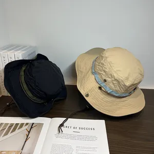 Detail of thin quick-dry sun hat with adjustable chin strap and side metal buttons