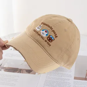 Detail of khaki cotton baseball cap with cute animal embroidery and distressed brim
