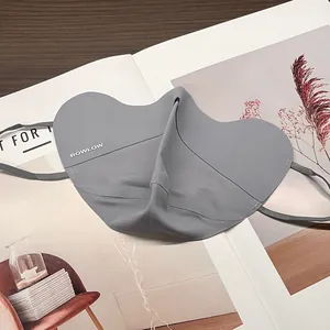 Detail of grey UPF50+ ice silk sun mask with BOWLOW logo on lifestyle background