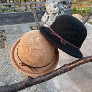 Women's chic woven bucket hat with bow accent and dome top for summer sun protection
