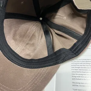 Detail view of khaki baseball cap interior showing black sweatband and durable stitching
