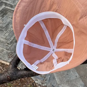 Detail of caramel nylon cotton sun hat interior showing stitching and adjustable chin strap