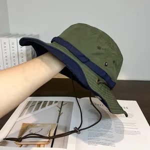 Detail of army green quick-dry bucket hat featuring metal eyelets and adjustable wind cord