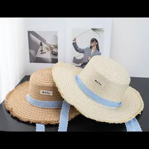 Flat top straw sun hats with frayed edges and blue checkered ribbons for summer beach beach