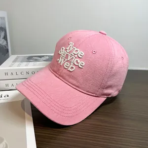 Macro detail of high-quality pink cotton baseball cap with white 3D letter embroidery