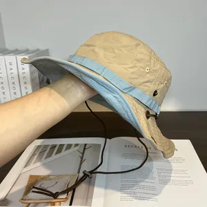 Detail of outdoor sun hat with side metal snaps and adjustable windproof drawstring