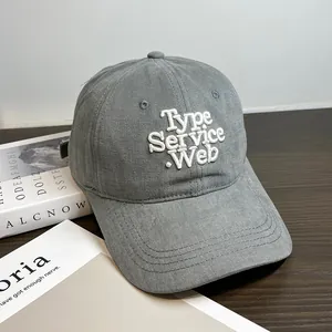 Detail shot of heavy cotton dark grey baseball cap with white 3D letter embroidery
