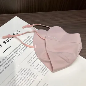 Detail of pink ice silk sun mask showing breathable pores and adjustable ear straps