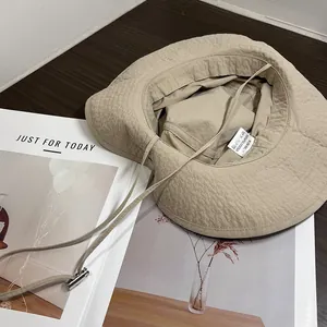 Beige wide brim sun hat with adjustable drawstring and UV protection for outdoor hiking