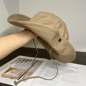 Detail of adjustable windproof rope and metal buckle on a khaki outdoor sun hat