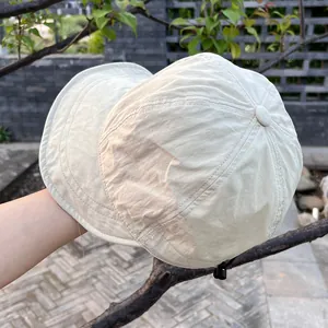 Detail of lightweight nylon sun hat showing water-resistant fabric and adjustable drawstring