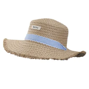 French style sun straw hat with blue plaid ribbon and frayed edges for summer beach