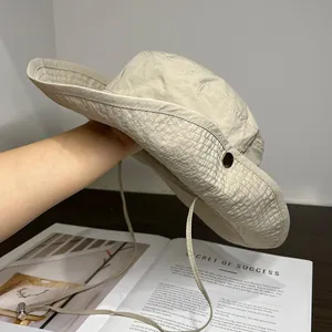 Detail of outdoor sun hat featuring waterproof fabric and adjustable windproof chin strap