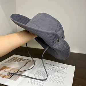 Close-up of quick-dry nylon sun hat with adjustable windproof cord and metal button detail