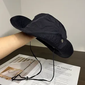Detail of a black sun hat showing the lightweight fabric texture and windproof cord
