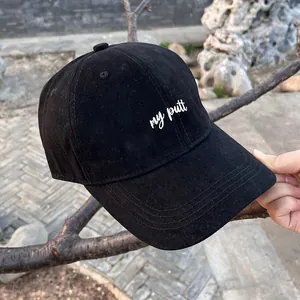 Detail shot of black cotton baseball cap featuring white cursive my putt embroidery