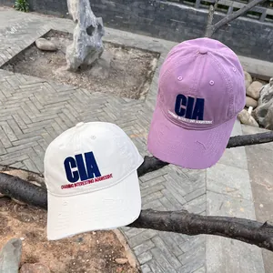 Close-up of CIA embroidery and distressed ripped brim on vintage cotton baseball caps