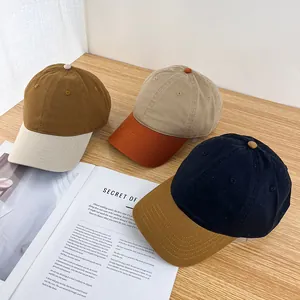 Detailed view of three contrast color baseball caps on a wooden desk with magazines
