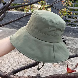 Detailed macro of olive green sun hat with ventilation eyelets and adjustable chin strap