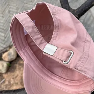 Pink vintage baseball cap with adjustable metal buckle and cotton strap detail