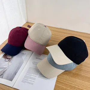Detail view of multi-color block cotton baseball caps in burgundy, beige and black