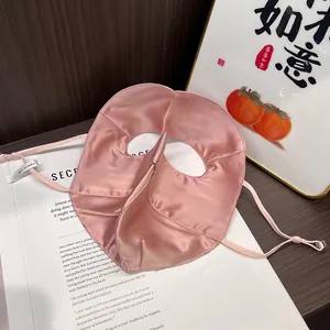 Detailed macro view of 100% mulberry silk sun mask with adjustable ear straps