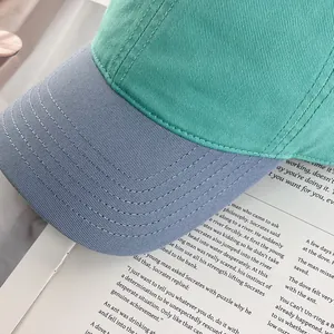 Detailed close-up of reinforced stitching on the two-tone cotton twill baseball cap brim