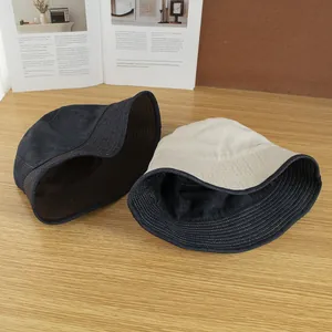 Reversible blue denim and beige canvas sun bucket hat with contrast stitching for women