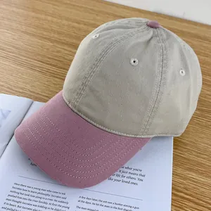 Close-up of contrast color cotton baseball cap on a book with fine stitching details