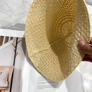 Handwoven breathable straw bucket hat in light yellow with intricate knit pattern details