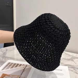 Detail of hand-woven black hollow out crochet sun hat showing breathable knit texture