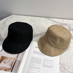 Detailed texture of black and khaki flat top military caps on a marble surface