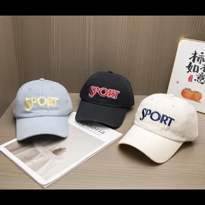 Detailed embroidery on colorful baseball caps displayed on a rustic wooden table