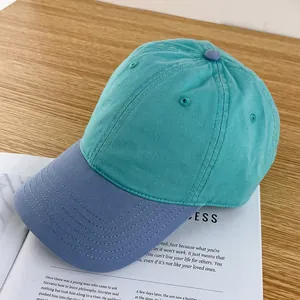Detail of teal and grey-blue two-tone baseball cap with cotton twill texture