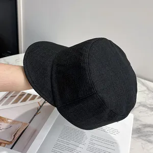 Close-up of black knitted retro equestrian cap with fine textured material on magazine