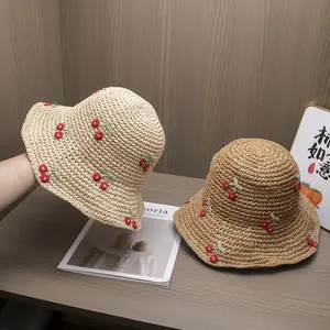 Handmade straw sun hat with cherry embroidery and wavy brim for summer beach travel