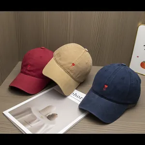 Detailed embroidery of small heart and 'C' letter on cotton twill baseball caps