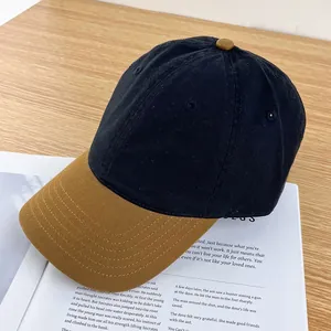 Detail of color-block baseball cap with contrast brim on vintage magazine and wooden table