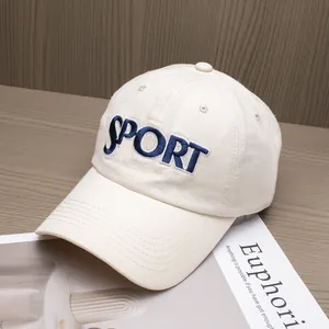 Detail of high-quality navy blue SPORT embroidery on the cream cotton baseball cap