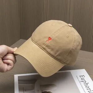 Close-up of heart and C letter embroidery on khaki cotton canvas baseball cap