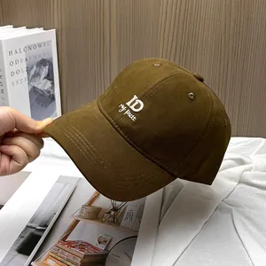 Detail of premium brown twill cotton baseball cap with 3D white ID letter embroidery