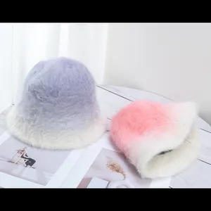 Close-up of soft gradient faux rabbit fur bucket hats in pink and purple pastel tones