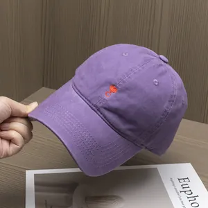 Close-up of a purple cotton baseball cap featuring a small red heart embroidery detail