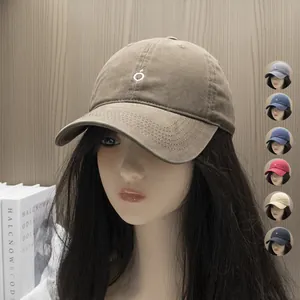 Coffee brown washed canvas baseball cap with minimalist white logo and color variants