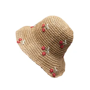 Handmade straw bucket hat with red cherry embroidery for summer beach vacations