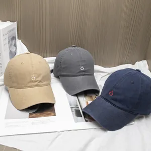 Minimalist soft top cotton baseball caps in khaki and navy blue on a vintage aesthetic background