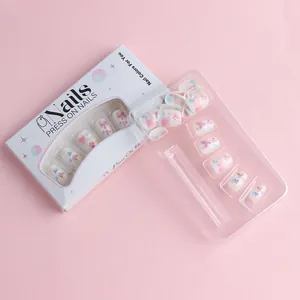 Detail of press-on nails with lavender floral butterfly patterns in white window packaging