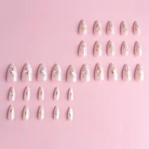 3D gold-plated almond press-on nails with marble texture and star rhinestones