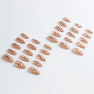 Golden star and moon press-on nails with cat-eye effect in almond shape